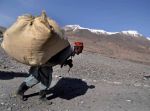 Un Afgano mentre trasporta merce per il bazar settimanale. In quei sacchi spesso viene nascosta l’eroina destinata al mercato dell’ Asia centrale.